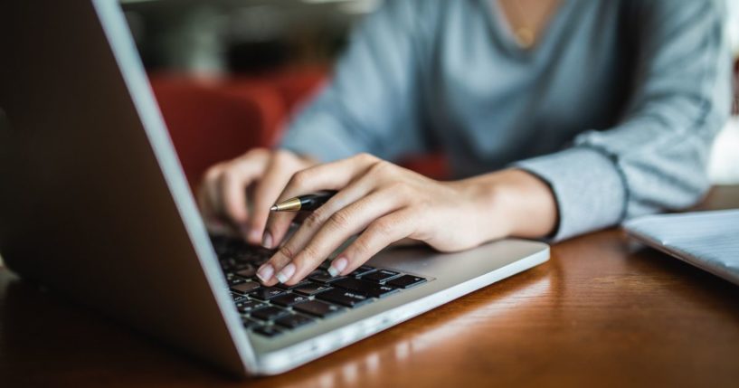 The above stock image is of a student in a library.