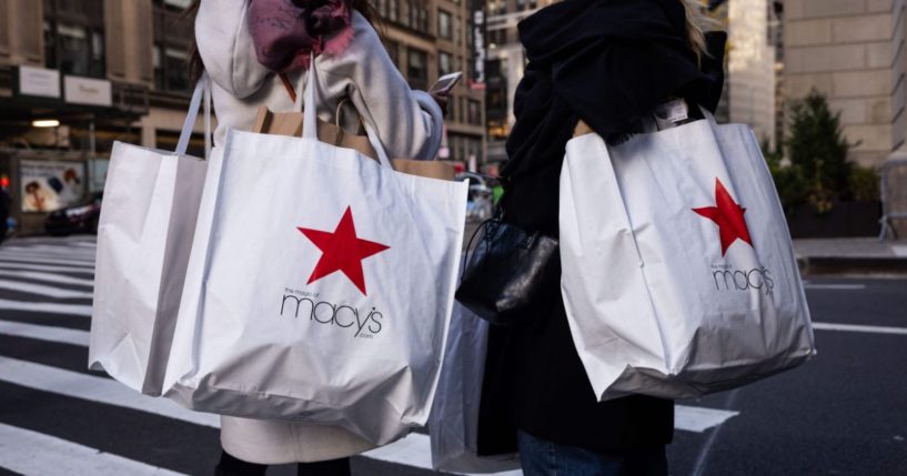 Shoppers carry Macy's bags during "Black Friday" in New York on Friday.