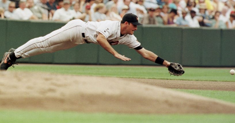 Baltimore Orioles third baseman Ryan Minor dives for a ball hit by the Detroit Tigers' Brad Ausmus during a game in Baltimore on Aug. 8, 1999. Minor died on Friday.