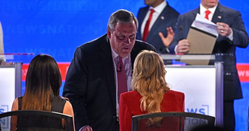 Former New Jersey Gov. Chris Christie speaks to moderator Megyn Kelly during a break in the fourth Republican presidential primary debate at the University of Alabama in Tuscaloosa, Alabama, on Wednesday.