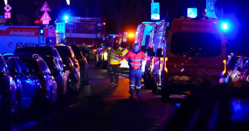 Medics wait near Charles University in downtown Prague, Czech Republic, on Thursday.