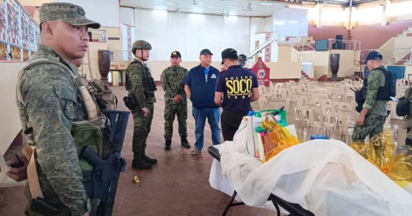 Law enforcement officers conduct an investigation after an explosion ripped through a Catholic Mass, killing several people and wounding several others, in Marawi City, Philippines, on Sunday.