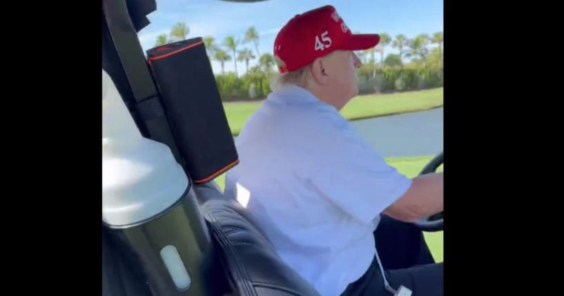 Donald Trump driving a golf cart