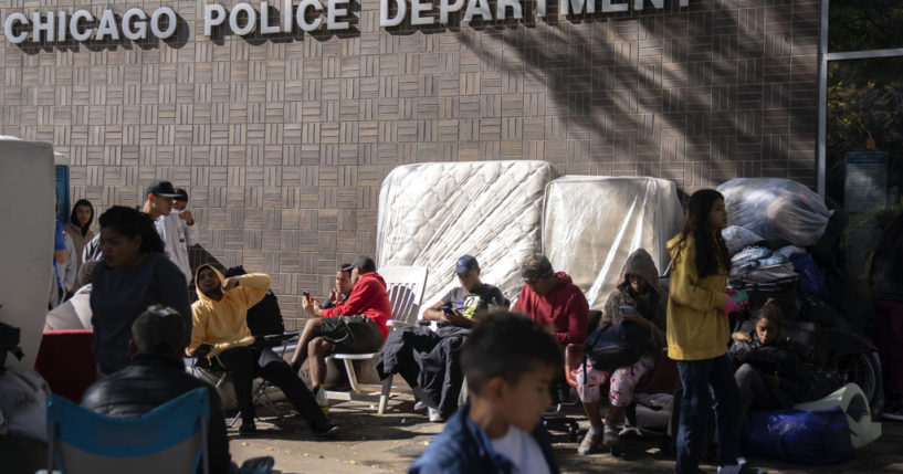 Migrants are camped outside of the 1st District police station, Oct. 7, in Chicago.