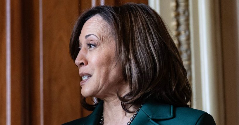 Vice President Kamala Harris speaks to Senate Majority Leader Chuck Schumer after being awarded a golden gavel outside of the Senate chamber at the U.S. Capitol in Washington, D.C., on Dec. 5.