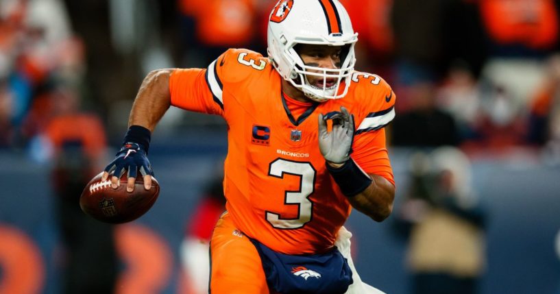 Russell Wilson of the Denver Broncos scrambles out of the pocket during the third quarter of a game against the New England Patriots at Empower Field at Mile High on Dec. 24 in Denver.