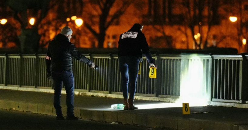 Forensic police work the scene of a fatal stabbing in Paris on Saturday.