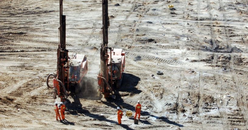 Two production drills complete a blast pattern while spotters observe at an open-pit copper mine in Zambia in this undated stock photo. On Saturday, seven miners were confirmed dead at a site in Chingola, Zambia.