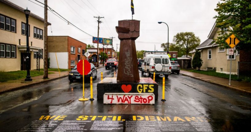 A statue of a raised fist stands at an intersection at the memorial known as "George Floyd Square" on May 25, 2022, in Minneapolis.