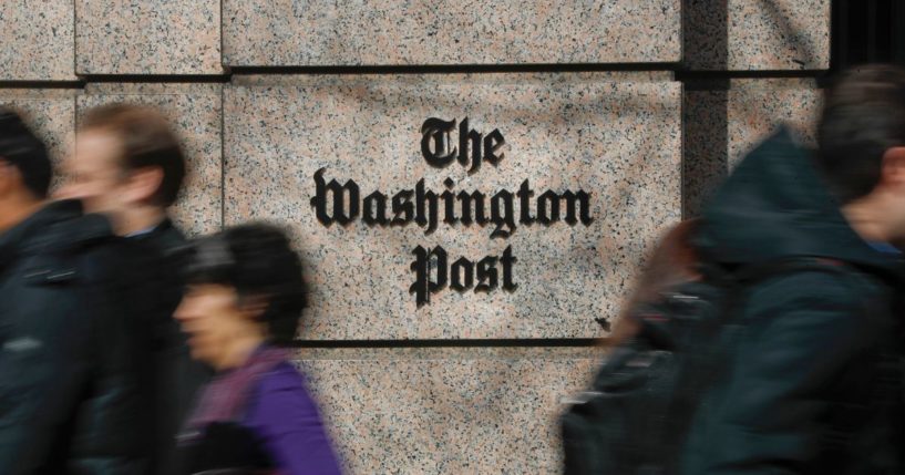 People walking by the home of The Washington Post newspaper