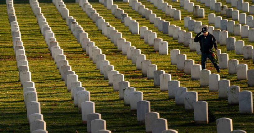 Shell Davis IV salutes after placing a wreath at Arlington National Cemetery during Wreaths Across America Day on Saturday in Arlington, Virginia.