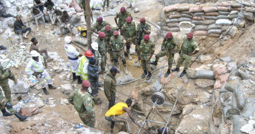 Zambian Army special forces officers follow the rescue operation of miners