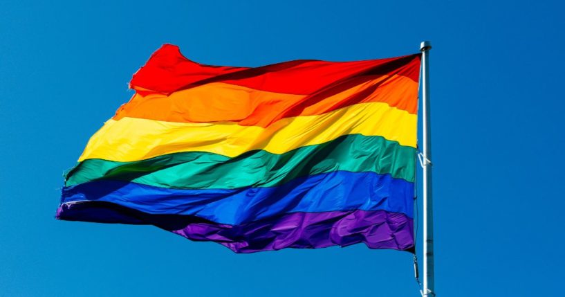 The LGBT flag flies in the above stock image.