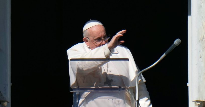 Pope Francis waves during the Angelus noon prayer from the window of his studio overlooking St.Peter's Square, at the Vatican, on Sunday.