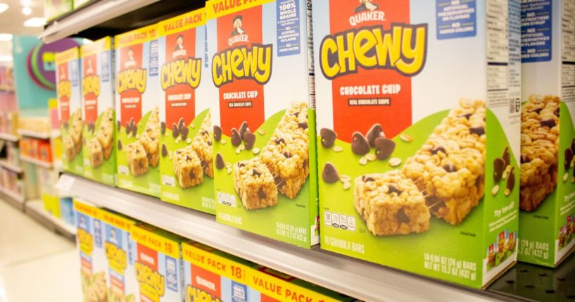 Quaker granola bars are seen on a store shelf in the above stock image.