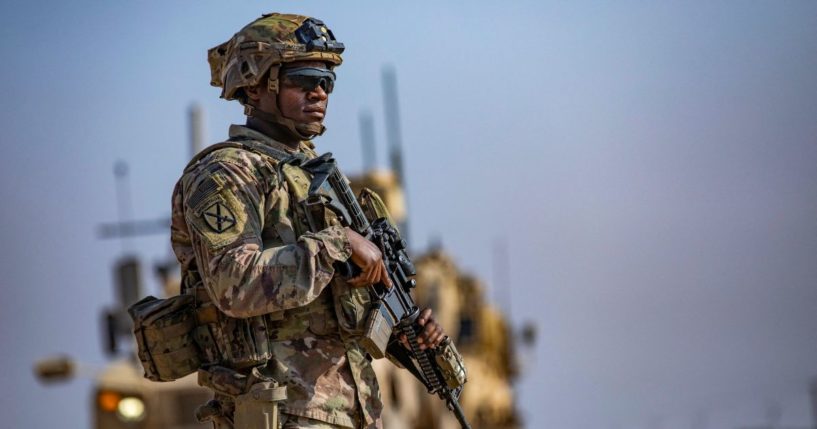 A U.S. soldier secures an area while patrolling the outskirts of Rumaylan in Syria's Kurdish-controlled northeastern Hasakeh province on Monday.