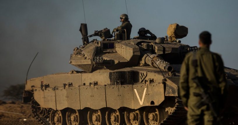 An Israeli soldier looks at a tank near the border with the Gaza Strip on Tuesday.