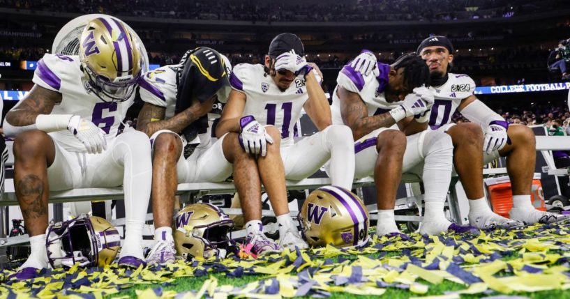 Washington Huskies players react to losing the 2024 CFP National Championship game.