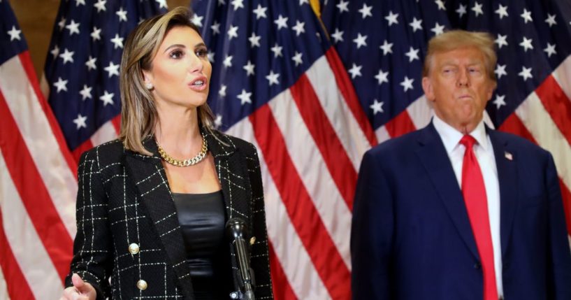 Former President Donald Trump stands with his lawyer Alina Habba as she speaks to the media following closing arguments in his civil fraud trial on Thursday in New York City.