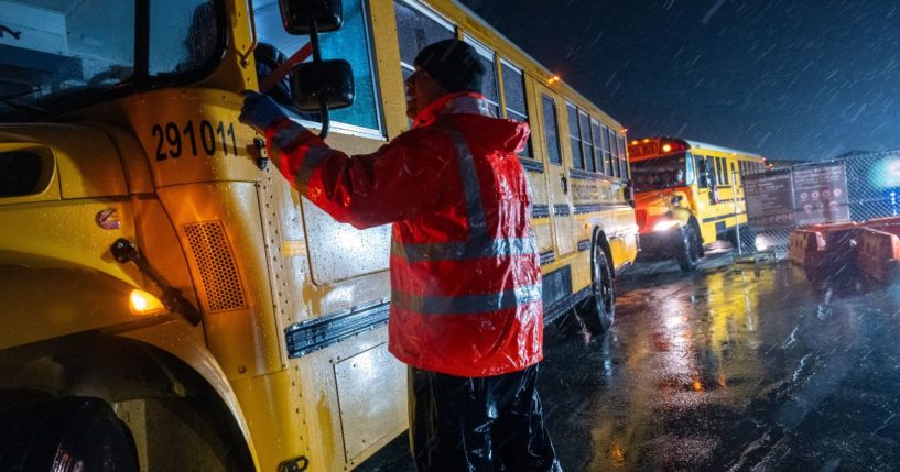 Nearly 2,000 migrants are evacuated by school buses from tents at Floyd Bennett Field to a local high school in preparation for a storm with estimated wind speeds to be more than 70 mph on January 9 in the Brooklyn borough of New York City. More than 100,000 migrants have arrived in New York City over the last year.