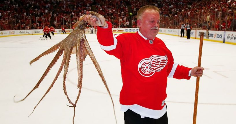 Al Sobotka, building operations manager for Olympia Entertainment, collects an octopus during a timeout at the last NHL game at Joe Louis Arena in Detroit between the New Jersey Devils and Detroit Red Wings on April 9, 2017.