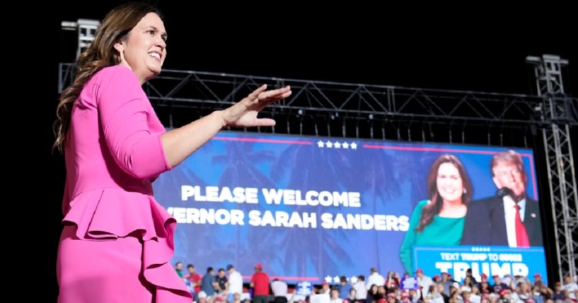 Arkansas Gov. Sarah Huckabee Sanders, walks across a stage after being introduced at a November campaign rally for former President Donald Trump in Hialeah, Florida.