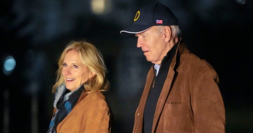 President Joe Biden and first lady Jill Biden walk across the South Lawn of the White House in Washington late Sunday after returning from a trip to Delaware.