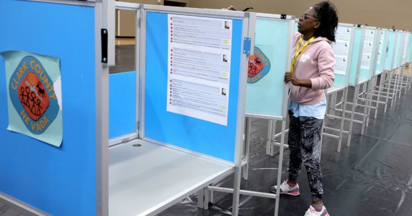 A Clark County Election Department worker sets up voting machine booths at a polling place in Las Vegas, Nevada, on Oct. 21, 2022.