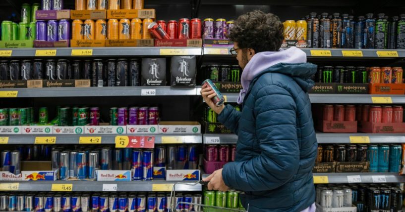 A man shops for energy drinks in a supermarket. New research suggests that energy drinks can be extremely harmful to children.