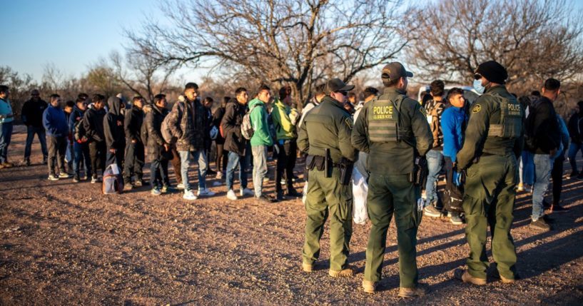 A group of migrants are processed by Border Patrol after crossing the river illegally near the highway on Feb. 4 outside Eagle Pass, Texas.