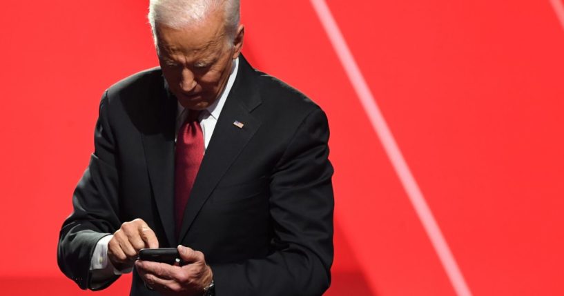 Then-presidential candidate Joe Biden looks at his phone after a debate at Otterbein University in Westerville, Ohio, on Oct. 15, 2019.