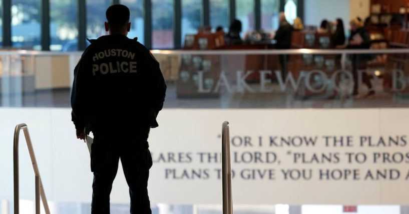 A police officer stands at the top of the steps inside the Lakewood Church in Houston, Texas, on Feb. 18.