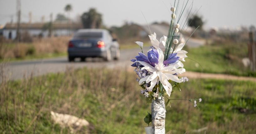 A stock photo shows a bouquet set up as a roadside memorial at the site of a fatal crash.