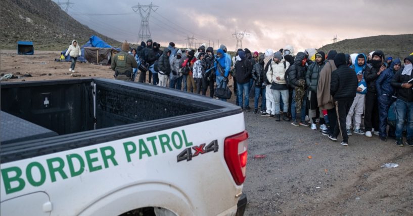 Illegal immigrants wait in line to be processed Jan. 2 by the Border Patrol at a makeshift camp near the U.S.-Mexico border in San Diego County, California.