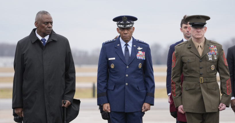 Defense Secretary Lloyd Austin, Chairman of the Joint Chiefs of Staff Gen. Charles Q. Brown, and Marine Corps. Sgt. Maj. Troy E. Black watch as an Army carry team moves the flag-draped transfer case containing the remains of U.S. Army Sgt. Kennedy Ladon Sanders, 24, of Waycross, Georgia, during a casualty return at Dover Air Force Base in Delaware on Friday. Sanders was killed in a drone attack in Jordan on Sunday.