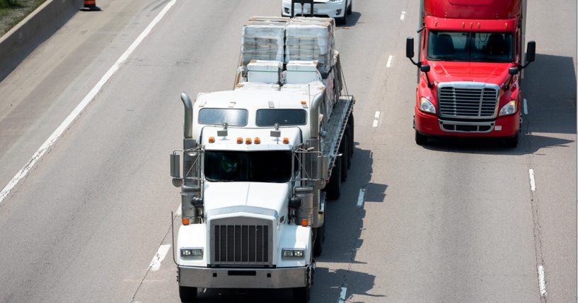 A stock photo of trucks on a highway.