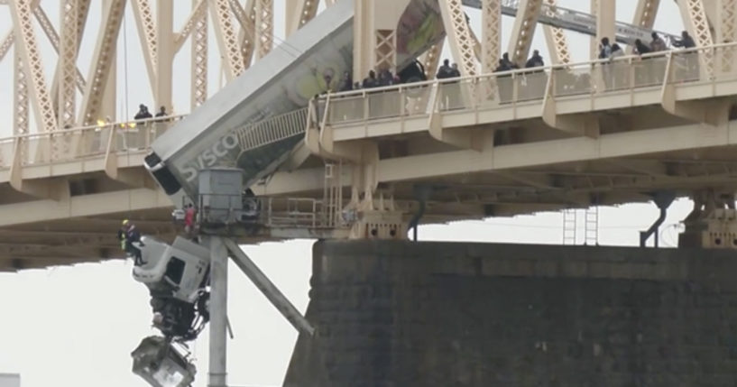 The driver of a semi-truck was pulled to safety Friday by firefighters in Louisville, Kentucky, following a crash that left the vehicle dangling over a bridge across the Ohio River.