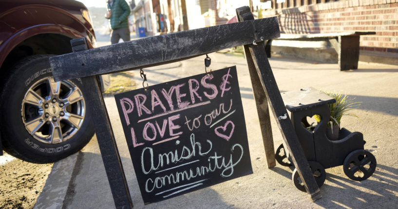 A sign of comforting words sits on the sidewalk outside an antique store in Spartansburg, Pennsylvania, on Thursday in the wake of the slaying of a pregnant Amish woman, 23, last week.