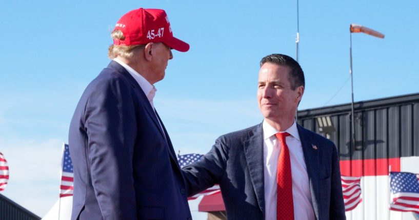 Republican presidential candidate and former President Donald Trump, left, greets GOP Senate candidate Bernie Moreno at a campaign rally March 16 in Vandalia, Ohio.