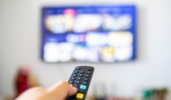 A remote control pointed at a television.