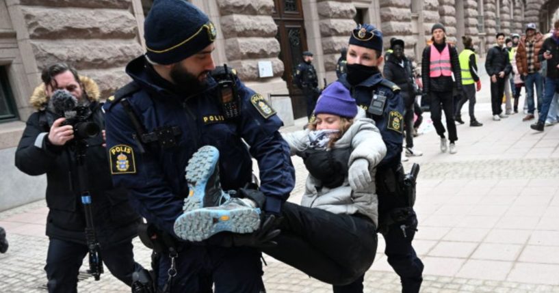 Swedish climate activist Greta Thunberg is carried away by police after staging a sit-in outside the Swedish parliament, the Riksdagen, to demonstrate for climate action, March 13, in Stockholm, Sweden.