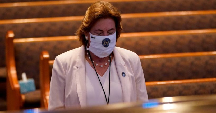 Harris County District Attorney Kim Ogg pauses by the casket of George Floyd during a funeral for Floyd in Houston, Texas, on June 9, 2020.