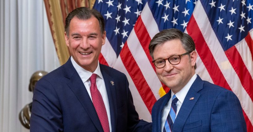 Tom Suozzi shaking hands with Mike Johnson