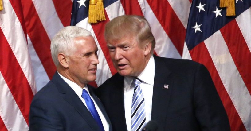 Then-presidential candidate Donald Trump, right, shakes hands with his vice presidential running mate Mike Pence in a file photo from July 2016.