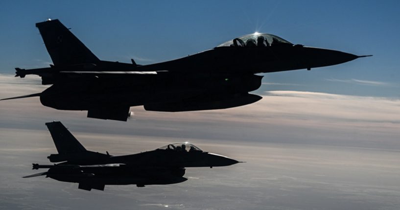 Airborne Polish Air Force F-16s are pictured in an October 2022 file photo from NATO exercises in Lask, Poland.