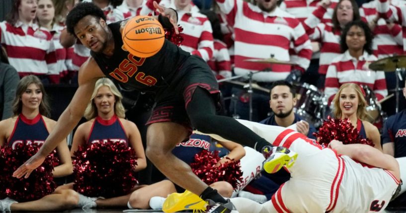 Southern California guard Bronny James, left, scrambles for the ball with Arizona guard Pelle Larsson during the first half of an NCAA college basketball game in the quarterfinal round of the Pac-12 tournament March 14, 2024, in Las Vegas.