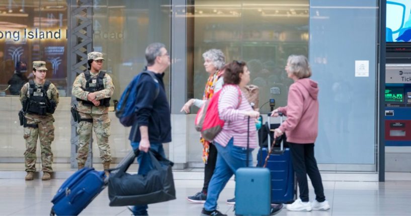 Commuters walk past New York National Guard soldiers at the Moynihan Train Hall at Penn Station, March 7, in New York.