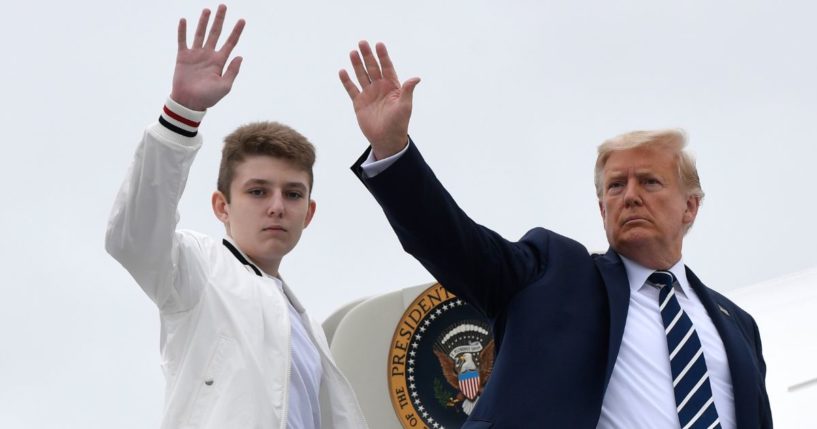 Then-President Donald Trump, right, and his son Barron Trump, left, wave from the top of the steps to Air Force One in Morristown, New Jersey, on Aug. 16, 2020.