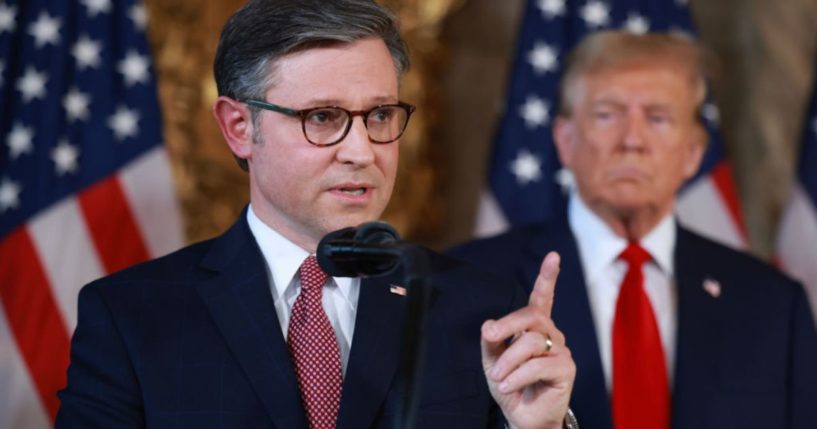 Republican presidential candidate former President Donald Trump listens as Speaker of the House Mike Johnson (R-LA) speaks during a press conference at Trump's Mar-a-Lago estate on April 12, in Palm Beach, Florida.