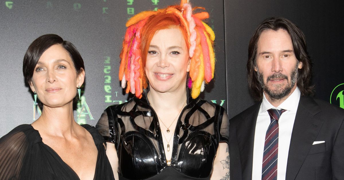 Hollywood stars Carrie-Anne Moss and Keanu Reeves posing for a picture with "The Matrix Resurrections" director Lana Wachowski.